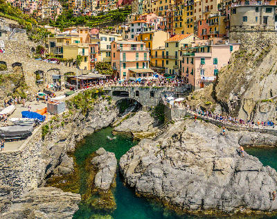 Aerial view of the promenade and bathing area in Manarola, overlooking the Ligurian Sea in Cinque Terre, Italy.
