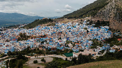 Panoramic view of Chefchaouen’s blue-painted medina nestled within the Rif Mountains in northern Morocco