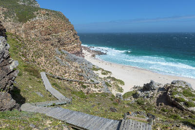 Wooden boardwalk descending the cliffs toward Dias Beach at Cape Point on the Cape Peninsula in Table Mountain National Park, South Africa.