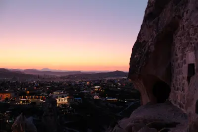 Sunset view from Uçhisar Castle overlooking Uçhisar village and distant hills in Cappadocia, Turkey.