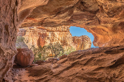 View from inside Stadsaal Cave overlooking sandstone cliffs and vegetation in the Cederberg Wilderness Area, Western Cape, South Africa.