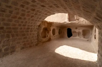 Rock-cut chamber with vaulted ceiling and carved niches inside Uçhisar Castle in Cappadocia, Turkey.