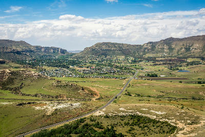 Aerial view of Clarens in the Free State, showing the village surrounded by sandstone mountains, farmland and highland valleys.