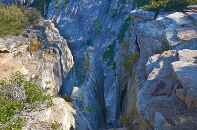 Deep granite fissures at Taft Point overlooking Yosemite Valley in Yosemite National Park, California.