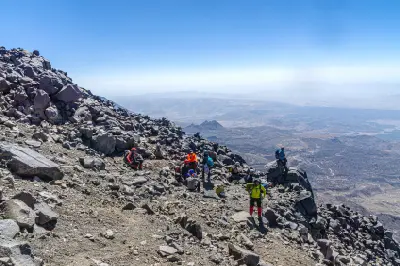 Mountaineers climbing across the steep rocky slopes of Mount Ararat in Ağrı, Eastern Turkey.