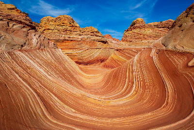 The Wave sandstone formation with flowing red and orange rock layers in Coyote Buttes Arizona