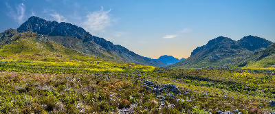 Panoramic mountain valley and fynbos landscape in Kogelberg Nature Reserve beneath the Hottentots-Holland Mountains, South Africa.