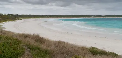 White sand and turquoise water at Twilight Beach near Esperance, Western Australia, beneath an overcast sky.