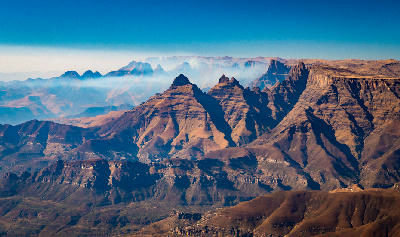 Aerial panorama of Cathedral Peak and surrounding sandstone spires in the Central Drakensberg, KwaZulu-Natal, South Africa.