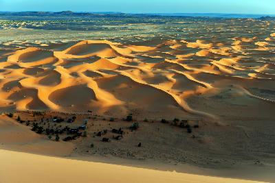 Aerial view of sand dunes and desert camps in the Erg Chebbi desert near Merzouga, Morocco.