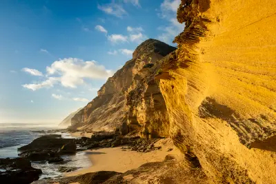 Golden light on the fossilised dune cliffs and coastal sandstone formations at Gericke's Point near Sedgefield on the Garden Route.