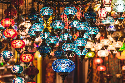 Traditional Turkish mosaic glass lamps glowing in a shop in Istanbul.