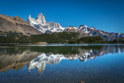 Mount Fitz Roy reflected in Laguna Capri with clear water in Patagonia, Argentina.