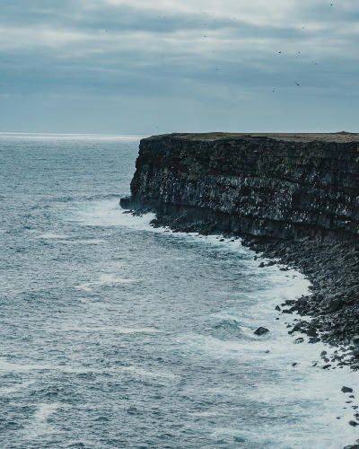Rugged basalt cliffs of Krýsuvíkurberg on the Reykjanes Peninsula, Iceland, where seabirds nest above the North Atlantic Ocean.