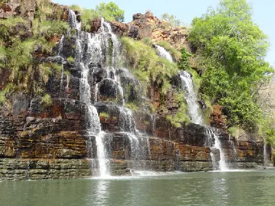 Water cascades over the terraced rock face of Kings Cascade into the Prince Regent River.