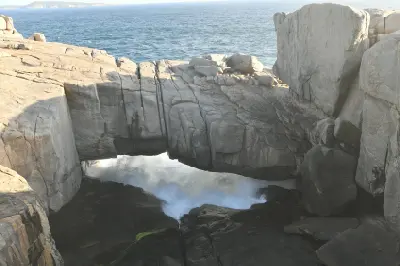 Natural Bridge above surging ocean waves in Torndirrup National Park near Albany, Western Australia.
