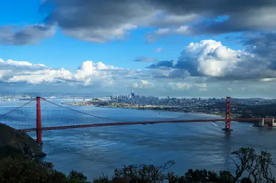 Golden Gate Bridge and San Francisco skyline viewed from Hawk Hill under dramatic clouds, Marin Headlands, California