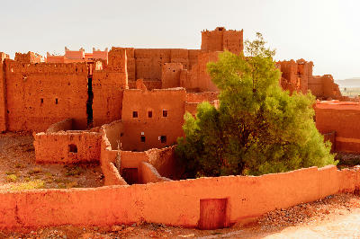Historic adobe walls and fortified structures inside Kasbah Taourirt in Ouarzazate, Morocco.