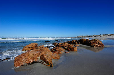 Rocky beach and coastal dunes beside the Atlantic Ocean at Green River Mouth in Namaqua National Park.