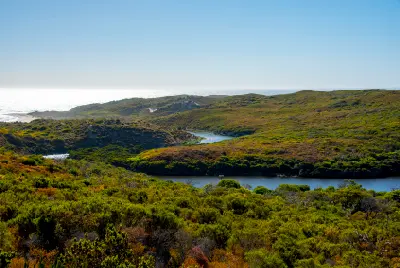 Margaret River winding through coastal heath with the Indian Ocean in the distance, Western Australia.