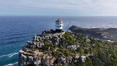 Cape Point lighthouse on a rocky cliff overlooking the Atlantic Ocean on the Cape Peninsula.