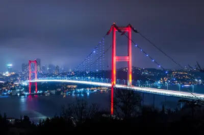 15 July Martyrs Bridge illuminated in red and blue at night over the Bosphorus in Istanbul, Turkey.