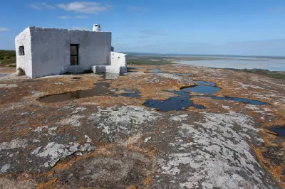Historic stone shepherd's cottage overlooking Langebaan Lagoon from the granite summit of Seeberg Viewpoint in West Coast National Park.