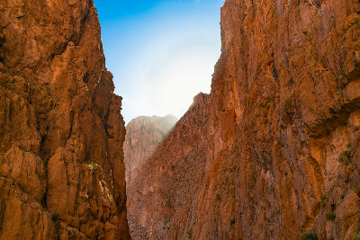 Sunlight illuminating the towering canyon walls of Todra Gorge in Morocco