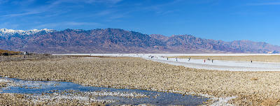People walking on Badwater Basin salt flats Death Valley California