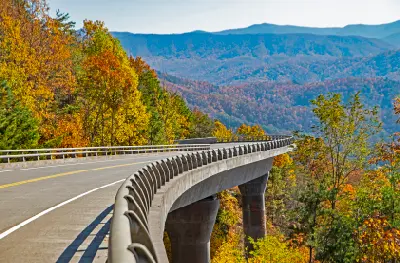 Elevated bridge and mountain roadway along Foothills Parkway overlooking autumn forest ridges in the Great Smoky Mountains.
