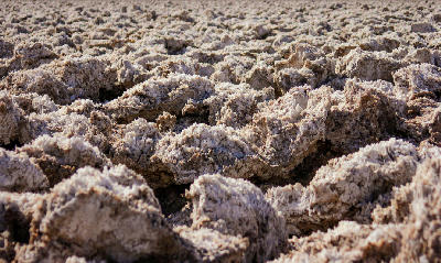 Detailed view of rough salt formations at Devils Golf Course in Death Valley National Park California showing compact jagged salt crust