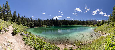 Turquoise lake surrounded by forest and trail at Valley of the Five Lakes, Jasper National Park
