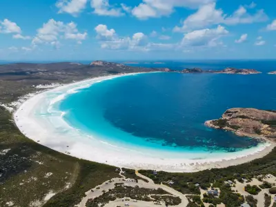 Aerial view of Lucky Bay’s white-sand beach, turquoise water and granite headlands in Cape Le Grand National Park, Western Australia.
