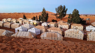 Traditional desert camp in the sand dunes of Merzouga in the Moroccan Sahara.