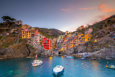 Colourful buildings of Cinque Terre stacked above the Mediterranean Sea, showing traditional Italian architecture along the Ligurian coast.
