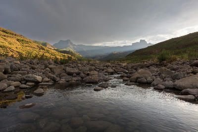 The Amphitheatre escarpment under dramatic storm light above the Tugela River in Royal Natal National Park, Drakensberg, South Africa.