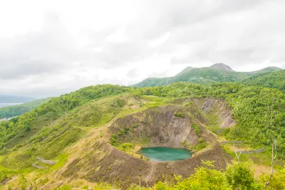 Konpira crater on Mount Usu showing a volcanic basin with a small lake within the Toya Caldera geopark in Hokkaido.