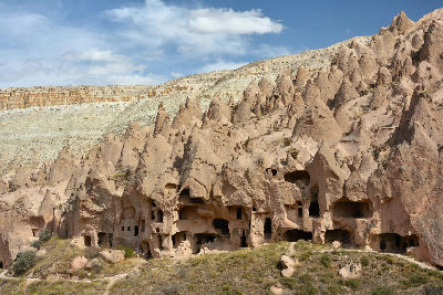 Zelve Open Air Museum showing cave dwellings and fairy chimneys carved into volcanic rock in Cappadocia, Turkey.