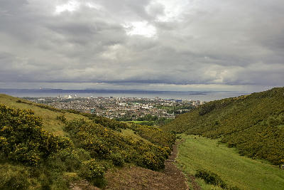 Path through the grassy slopes of Arthur’s Seat overlooking Edinburgh and the Firth of Forth.