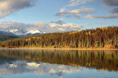 Patricia Lake at dawn with autumn forest reflections and snow-capped Trident Range peaks
