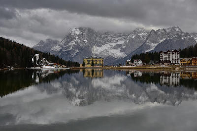 Lago di Misurina surrounded by the Dolomite mountains, with calm water reflecting alpine peaks in northern Italy.