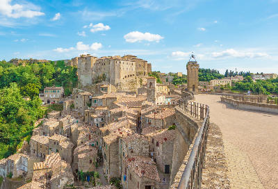 Medieval hill town of Sorano built on volcanic tuff rock, showing a square on the cliff edge with a bell tower in the Province of Grosseto, Tuscany, Italy.