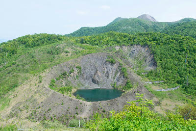 Konpira crater with a small lake on the slopes of Mount Usu in Hokkaido, Japan.