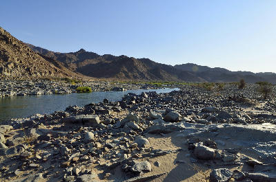 The Orange River flowing through rocky desert terrain in the Richtersveld, with rugged mountains rising along the South Africa–Namibia border.