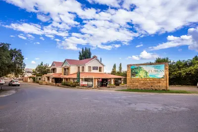 Entrance sign and roadside shops in Clarens, a popular mountain town in the eastern Free State, South Africa.