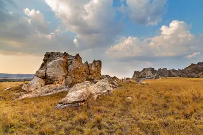 Eroded sandstone formations beneath dramatic storm clouds in Isalo National Park, Madagascar