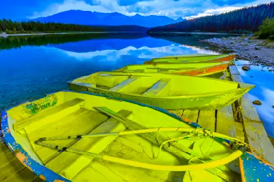 Rowboats tied at dock on Patricia Lake with mountain reflections and calm water