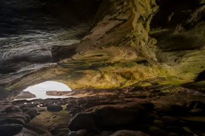 Layered sandstone formations and tidal pools inside Waenhuiskrans Cave near Arniston on the Overberg coast of the Western Cape, South Africa.