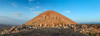 Ancient statues and burial mound on the summit terrace of Mount Nemrut, Turkey.
