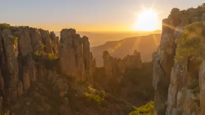 Sunrise illuminating the dramatic sandstone cliffs and rock pinnacles of the Valley of Desolation in Camdeboo National Park near Graaff-Reinet, Eastern Cape, South Africa.